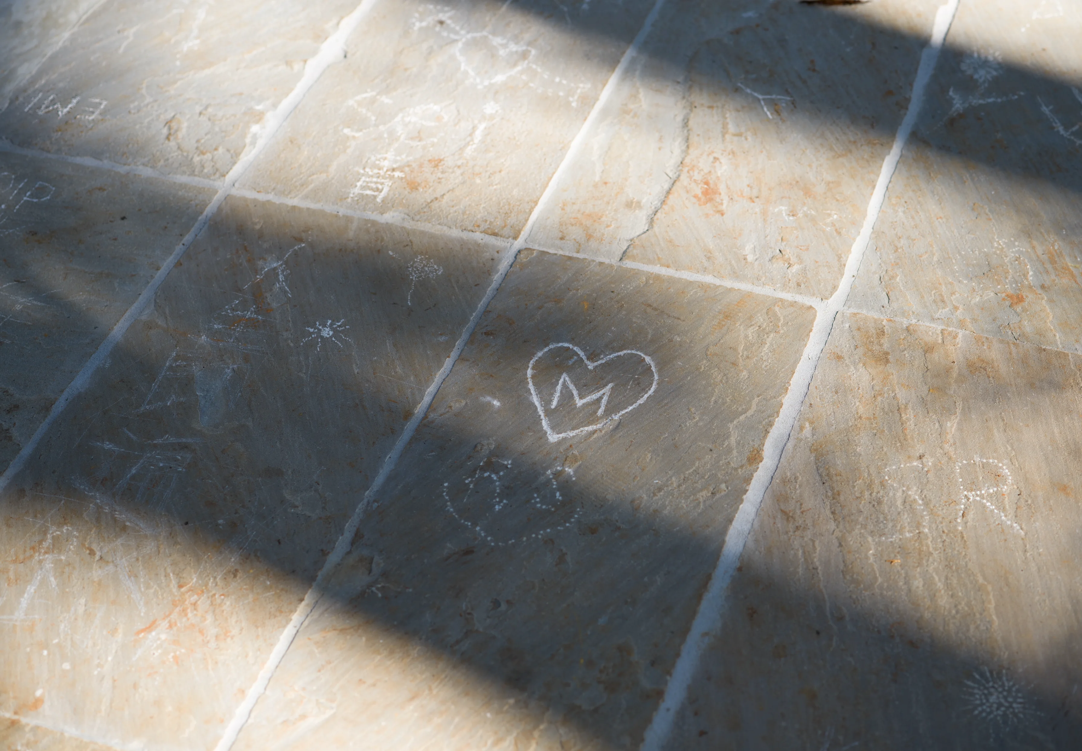 Close-up of a heart shape with the letter "M" carved by a visitor at Liminality, an interactive public artwork by Ewa Wes (Wesołowska) in Kamiyama, Japan.